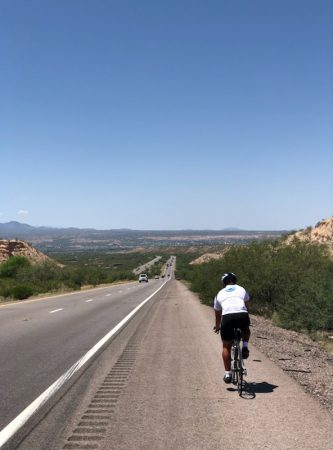 George cycling on desert road